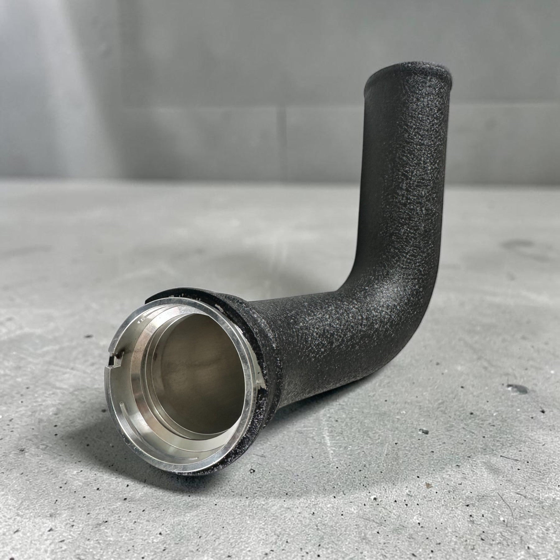 Palenon Performance black powder-coated aluminum charge pipe for BMW B46 and B48 engines with precision metal fitting.