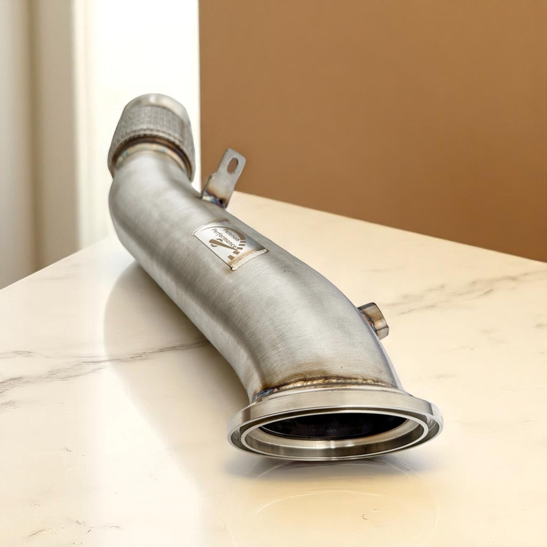 Palenon Performance stainless steel racing downpipe for B46 and B48 engines with TIG welded joints and metal badge