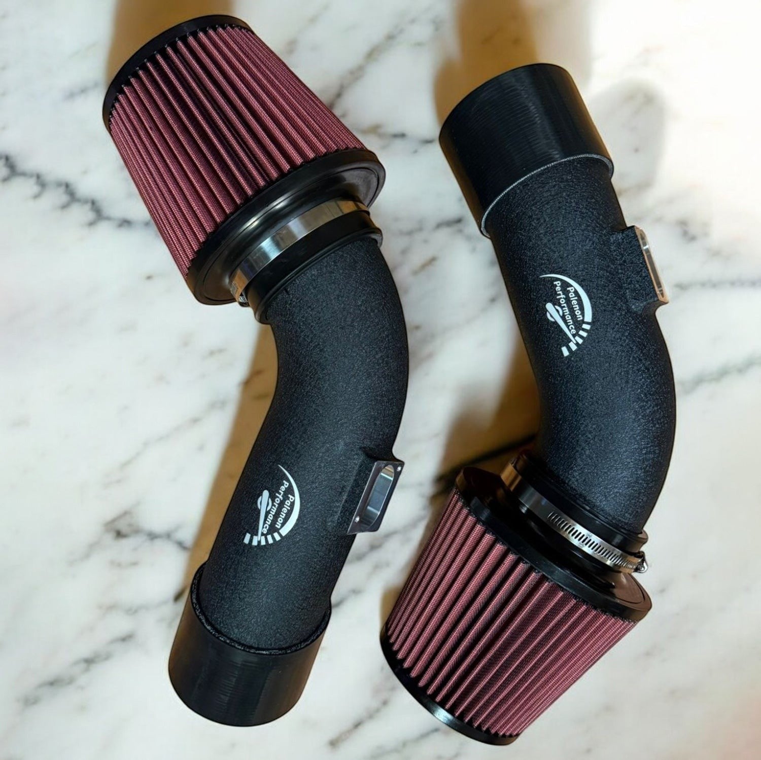 Palenon Performance dual cone cold air intake for BMW F10 M5 and F12 M6 with matte black pipes and red filters.
