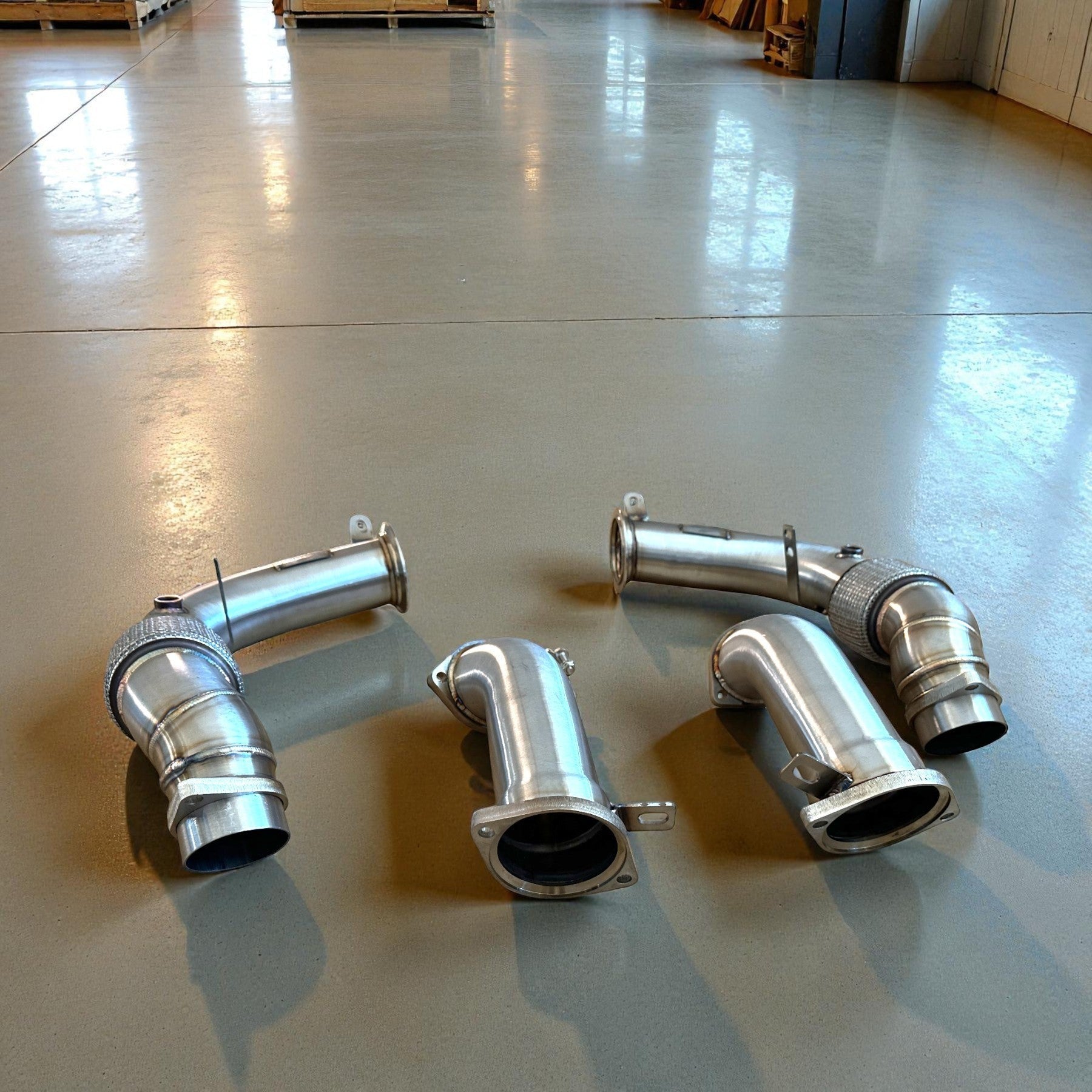 Palenon Performance stainless steel racing downpipes for BMW G90 and G99 M5, showing high-flow design and precision flanges.
