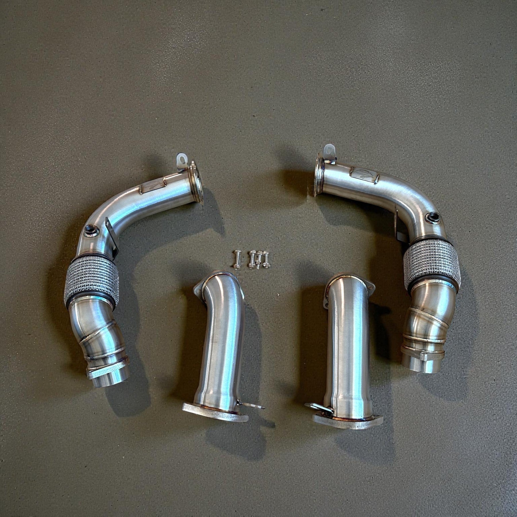 Palenon Performance stainless steel racing downpipes for BMW G90 and G99 M5, featuring high-flow design and CNC flanges.