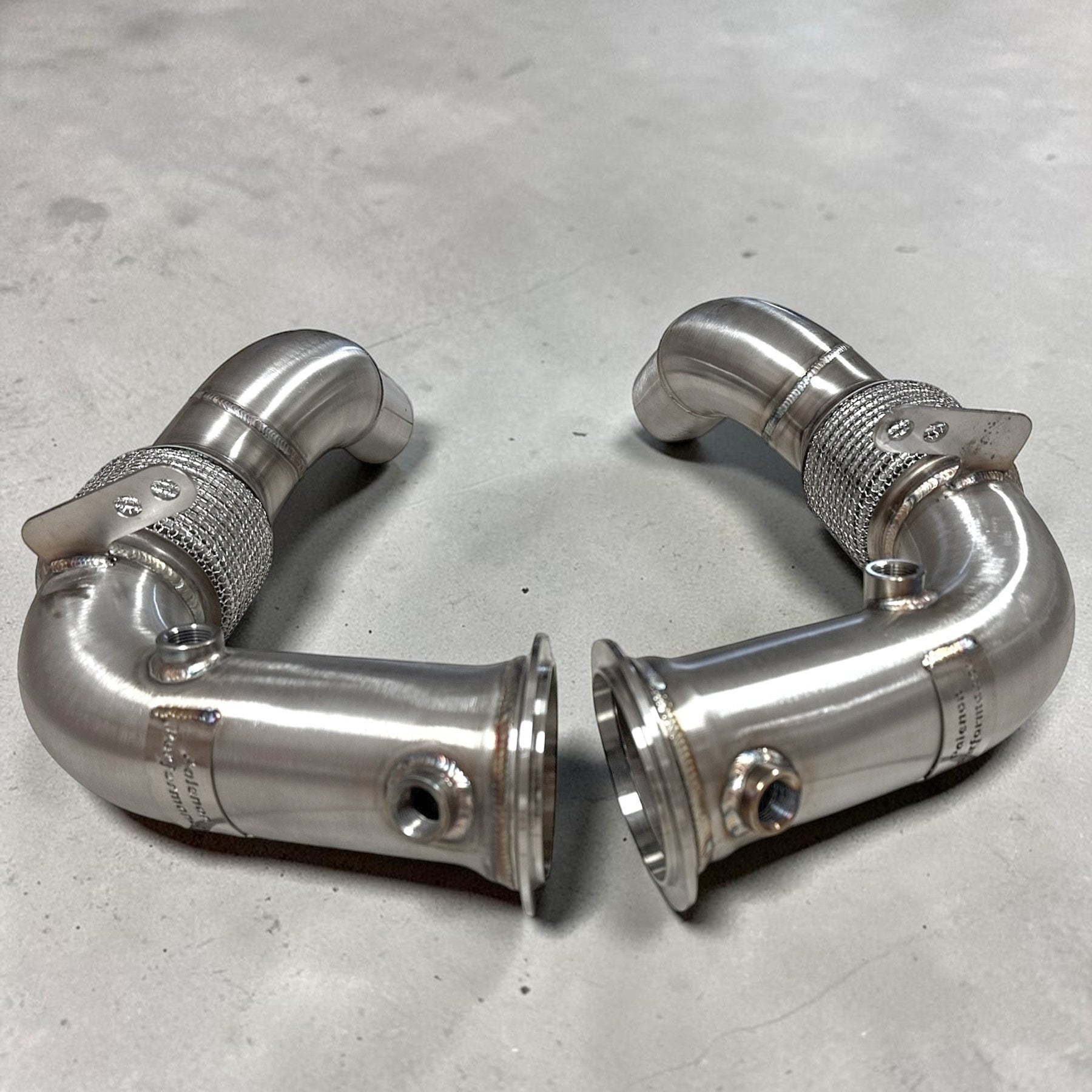 Palenon Performance stainless steel race downpipes for BMW S63 engines featuring v-band connections and flex joints.