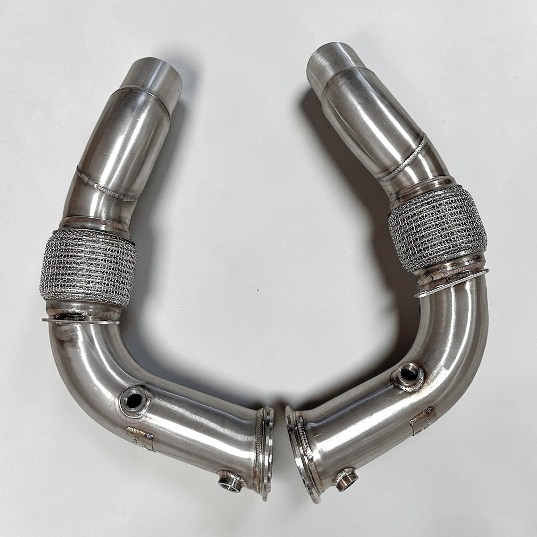 Palenon Performance stainless steel race downpipes for BMW S63 engines featuring v-band connections and flex joints.