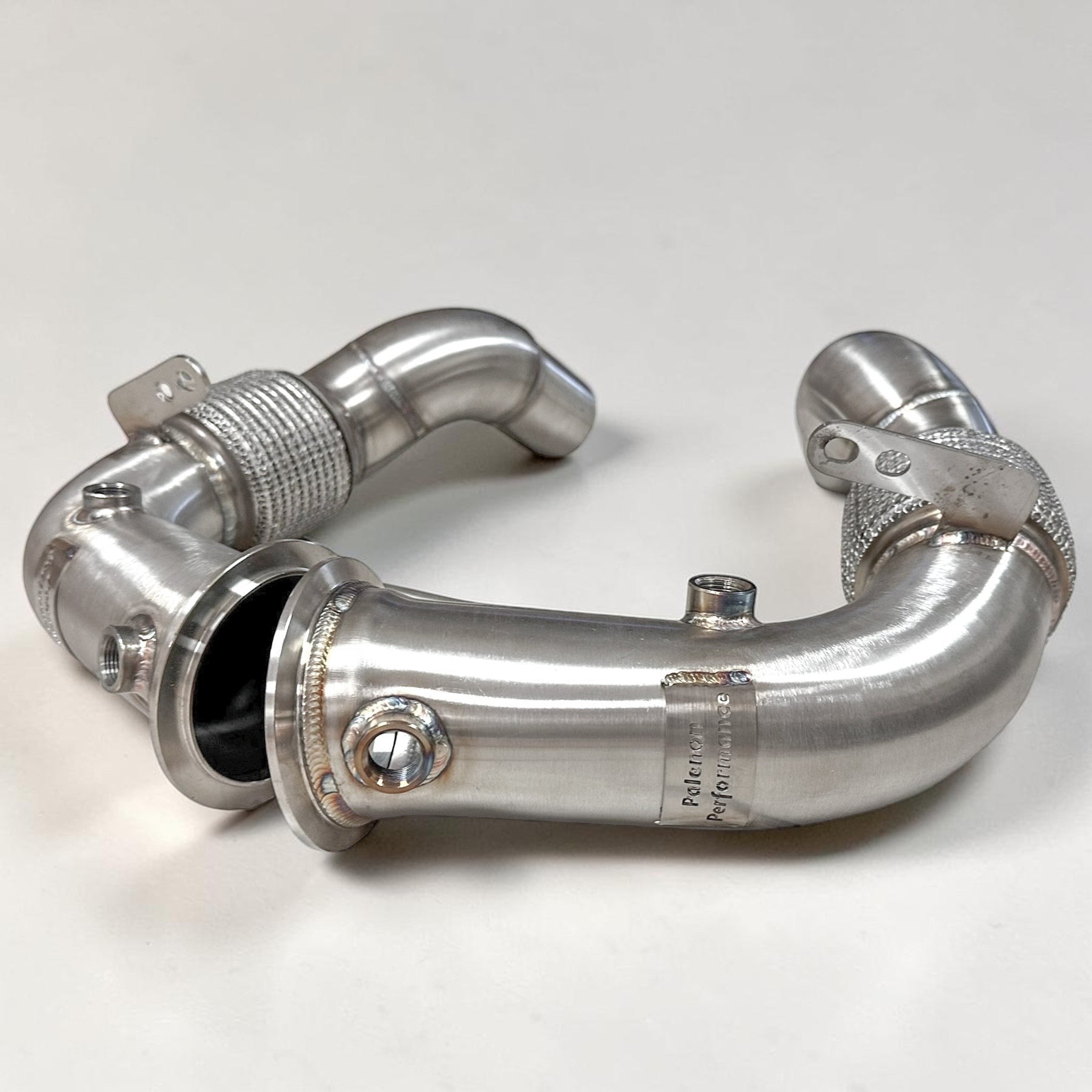 Palenon Performance stainless steel race downpipe for BMW S63 engine with v-band connection and O2 sensor bungs.