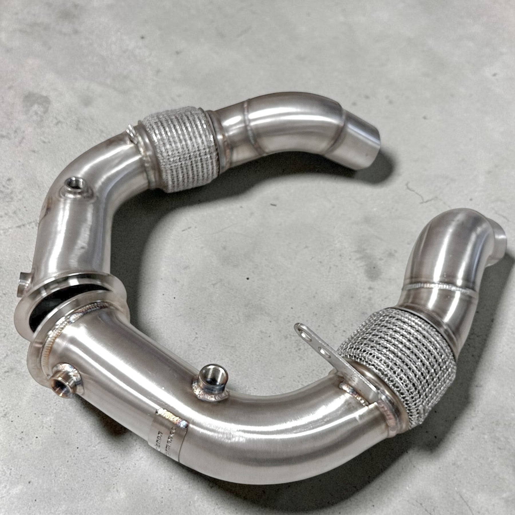 Palenon Performance stainless steel race downpipe for BMW S63 engines with v-band connections and flex sections.