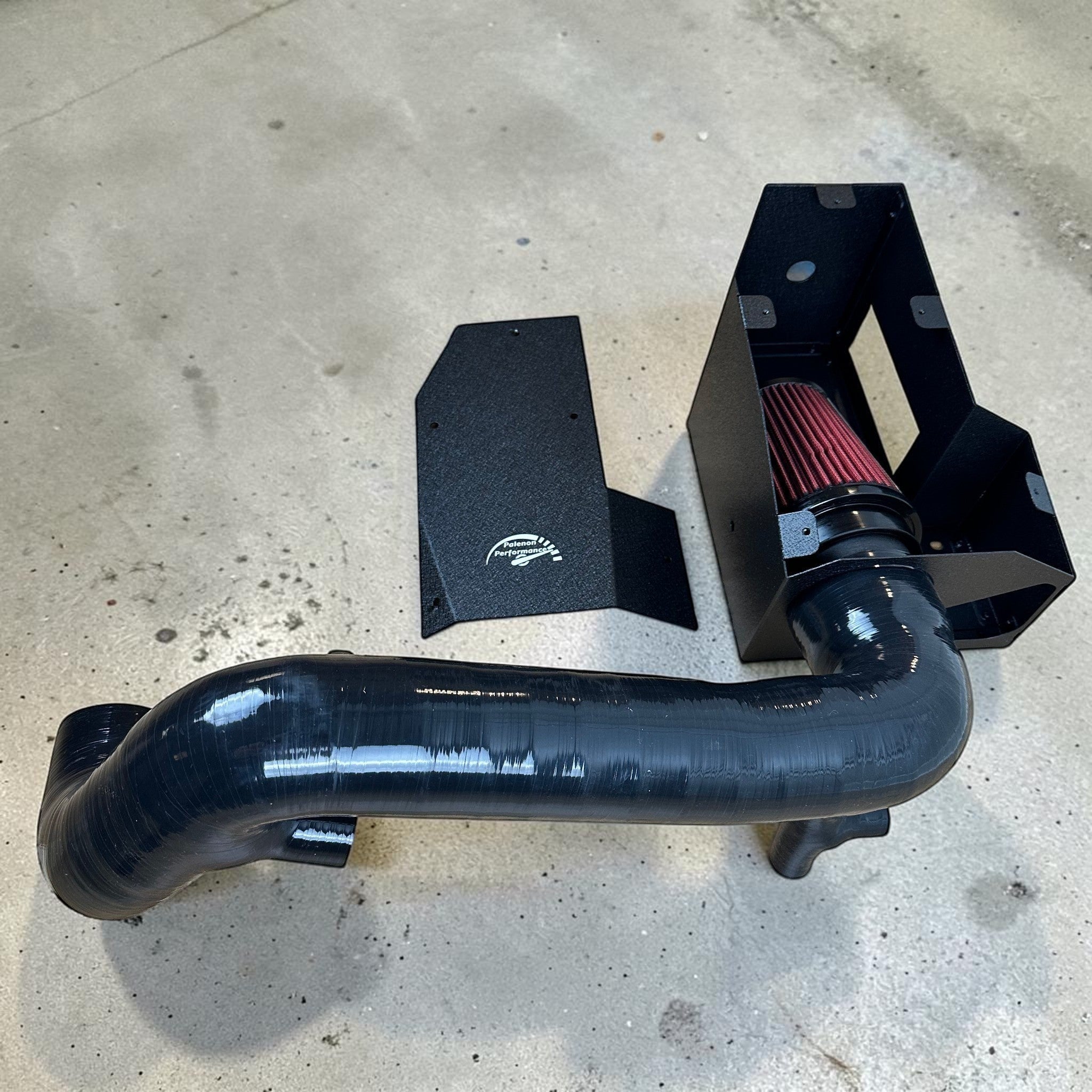 Palenon Performance M264 cold air intake kit with black powder-coated heat shield, silicone hose, and red air filter.