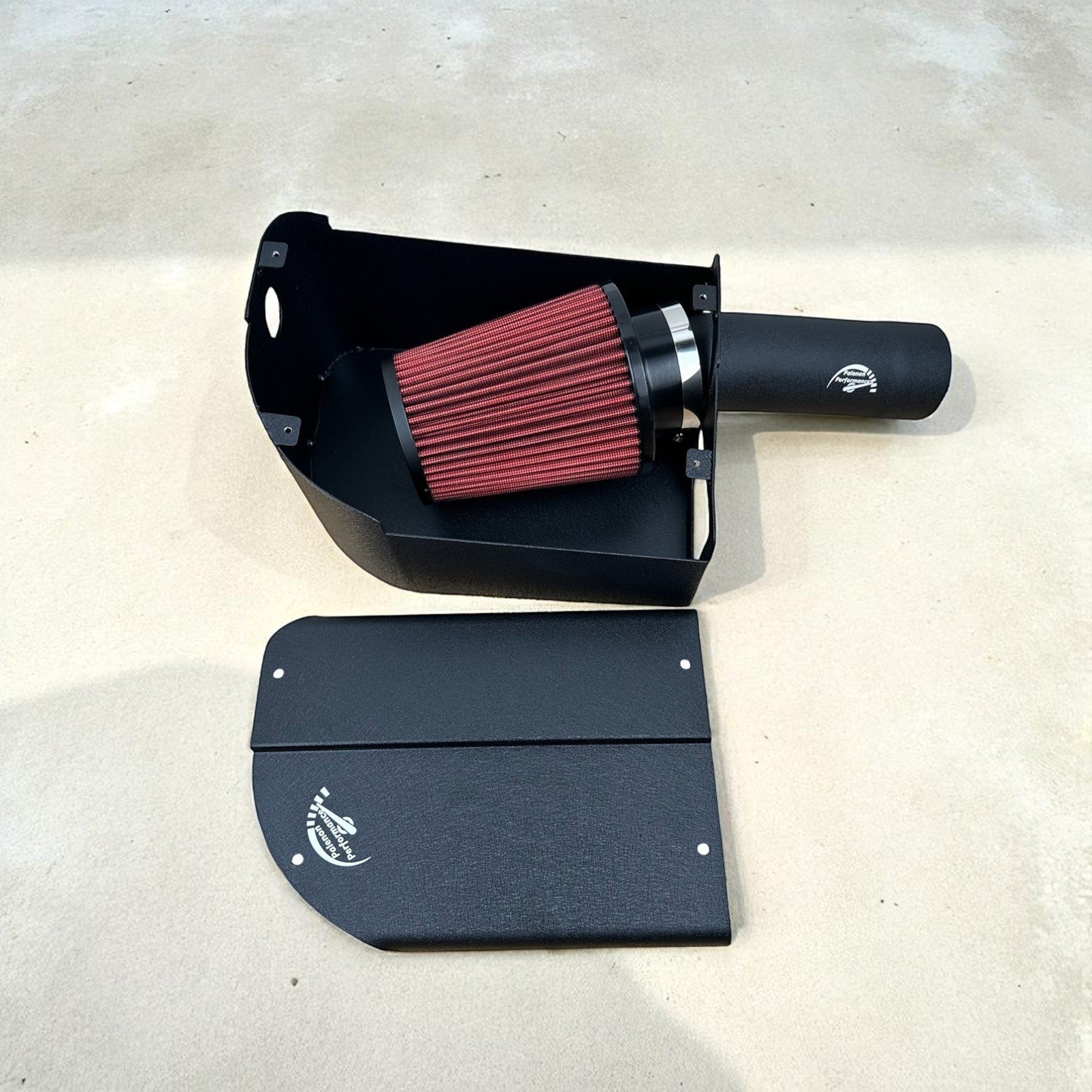 Palenon Performance cold air intake system with black aluminum heat shield and red reusable air filter for M274 engine.