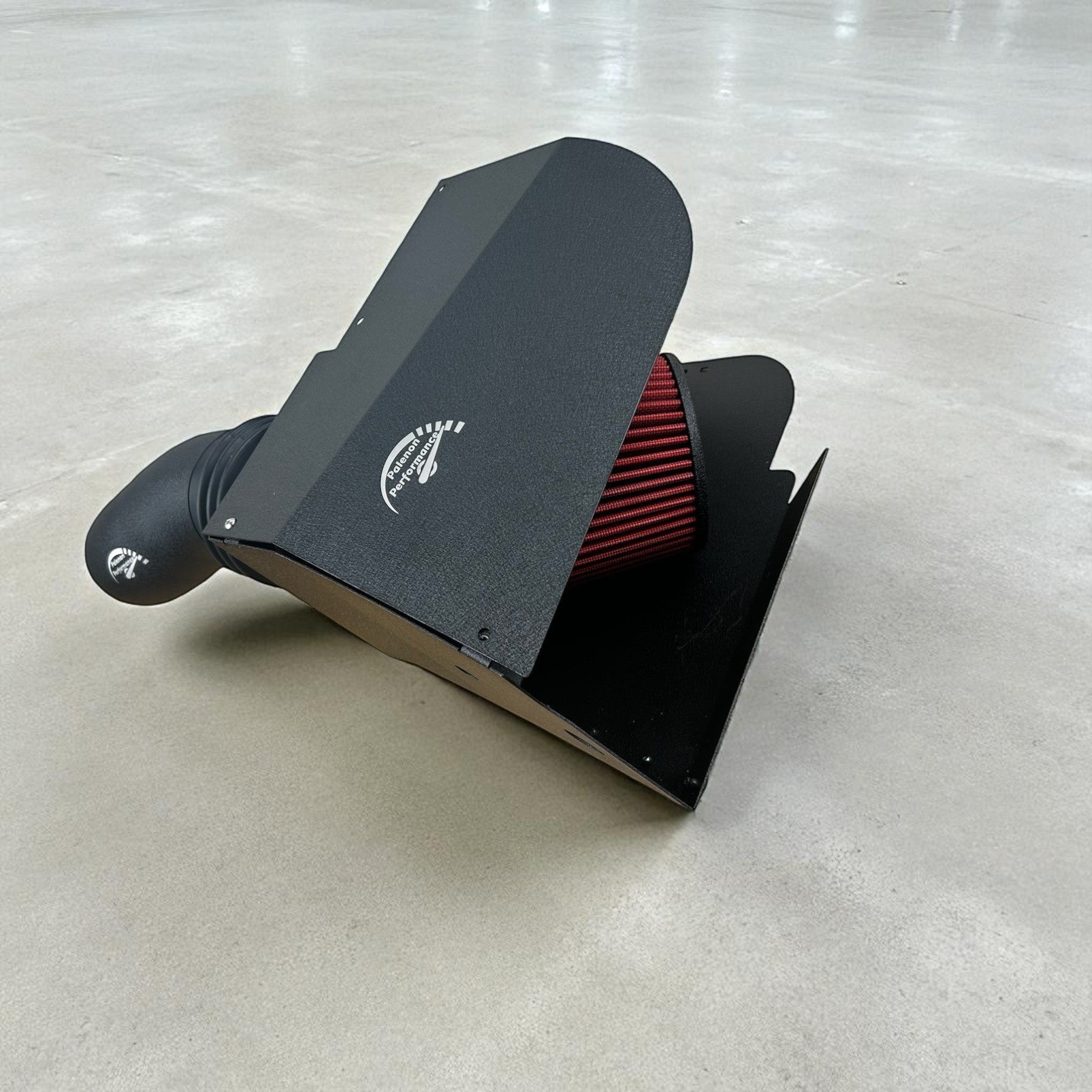 Palenon Performance cold air intake system for VW MK8 with black powder-coated heat shield and red cone air filter