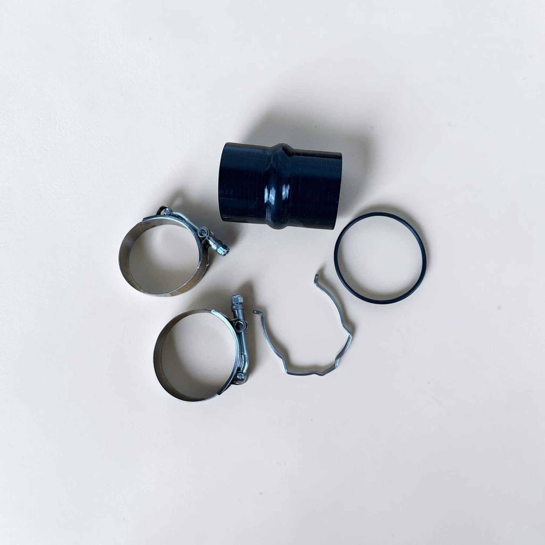 Palenon Performance N55 charge pipe installation hardware including silicone coupler, stainless clamps, and O-ring.