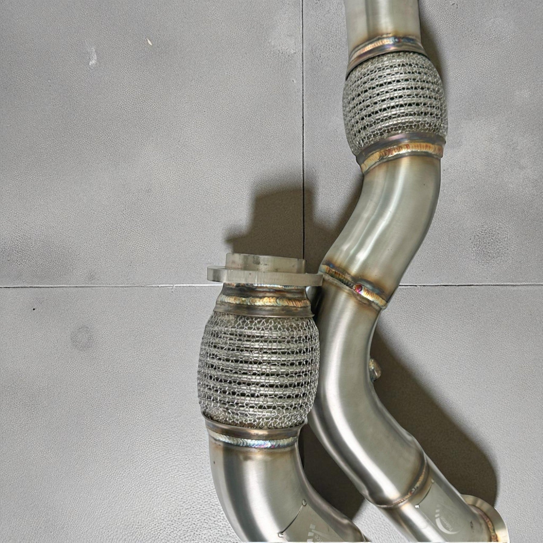 Palenon Performance stainless steel S55 racing downpipe with flexible mesh sections for BMW M3, M4, and M2 models.