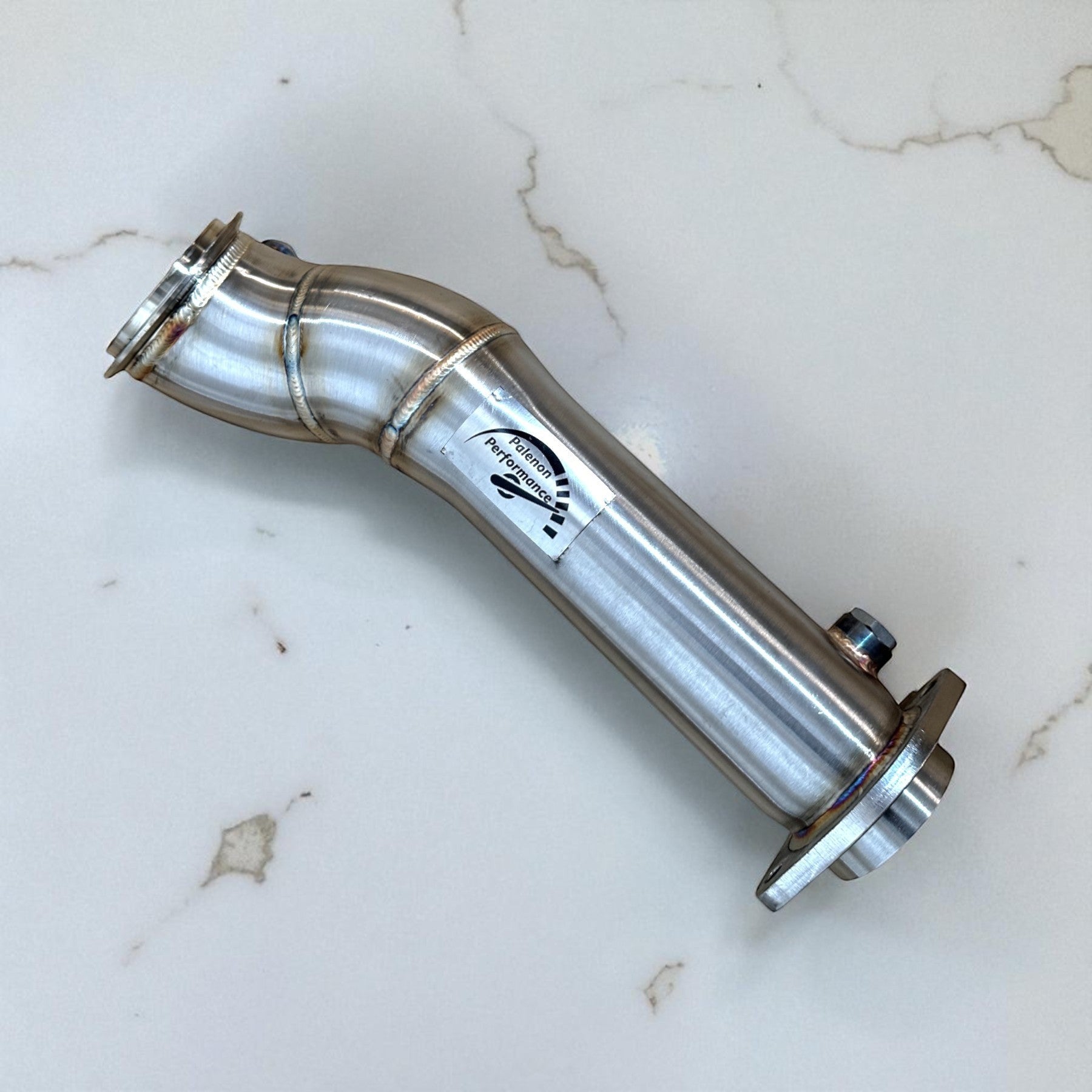 Palenon Performance stainless steel catless downpipe for BMW S58 engine with mandrel-bent design and branding sticker