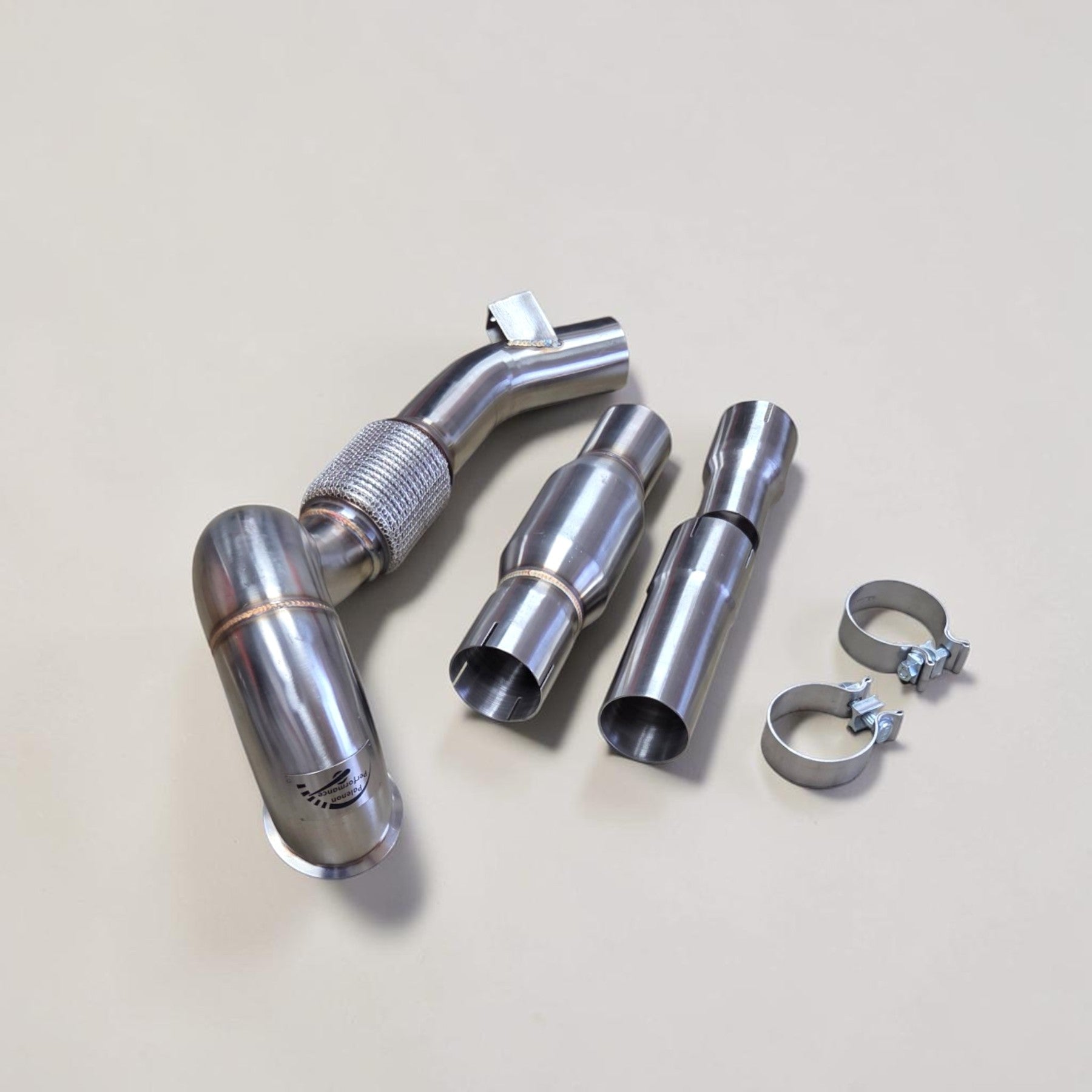 Palenon Performance stainless steel race downpipe kit for VW Golf MK7 with flex section, adapters, and clamps.