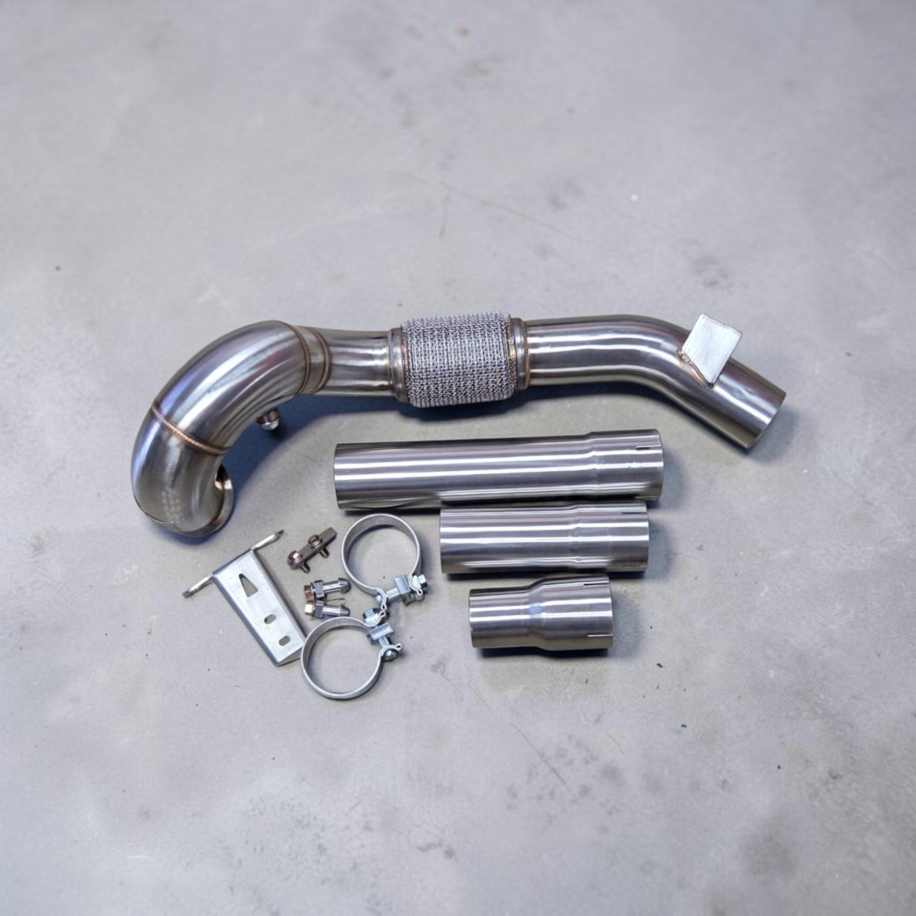Palenon Performance stainless steel race downpipe kit with flex section, adapters, and mounting hardware for VW Golf.