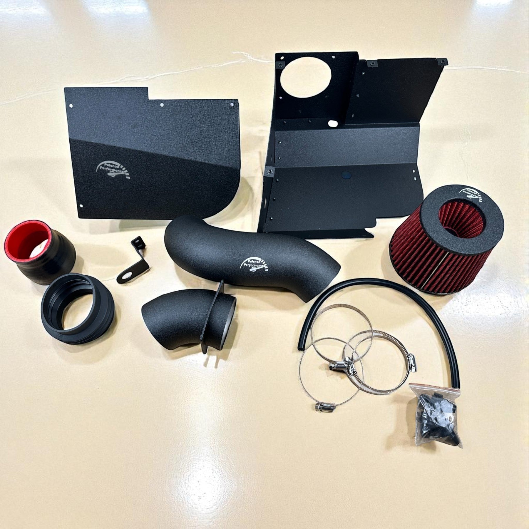 Palenon Performance cold air intake kit for VW MK8 with black powder-coated pipes, heat shield, and red cone filter.