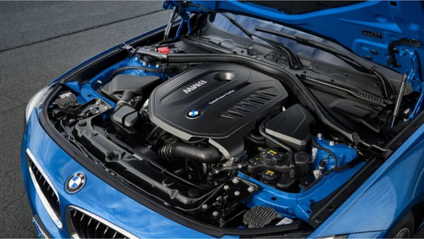 BMW B58 engine under the hood of a blue BMW, showcasing the TwinPower Turbo inline-6 engine design