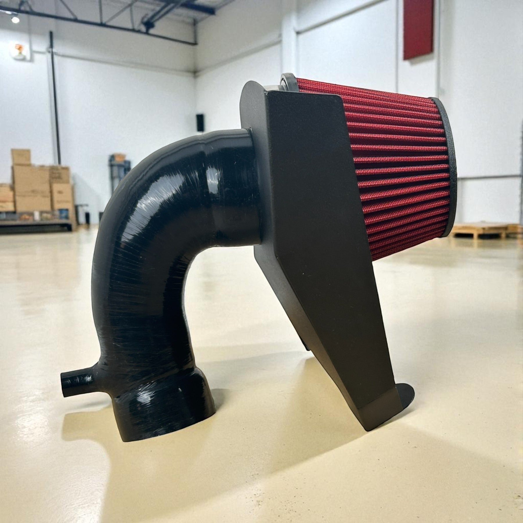 Palenon Performance cold air intake system with a red velocity stack filter and black silicone pipe for Audi B9