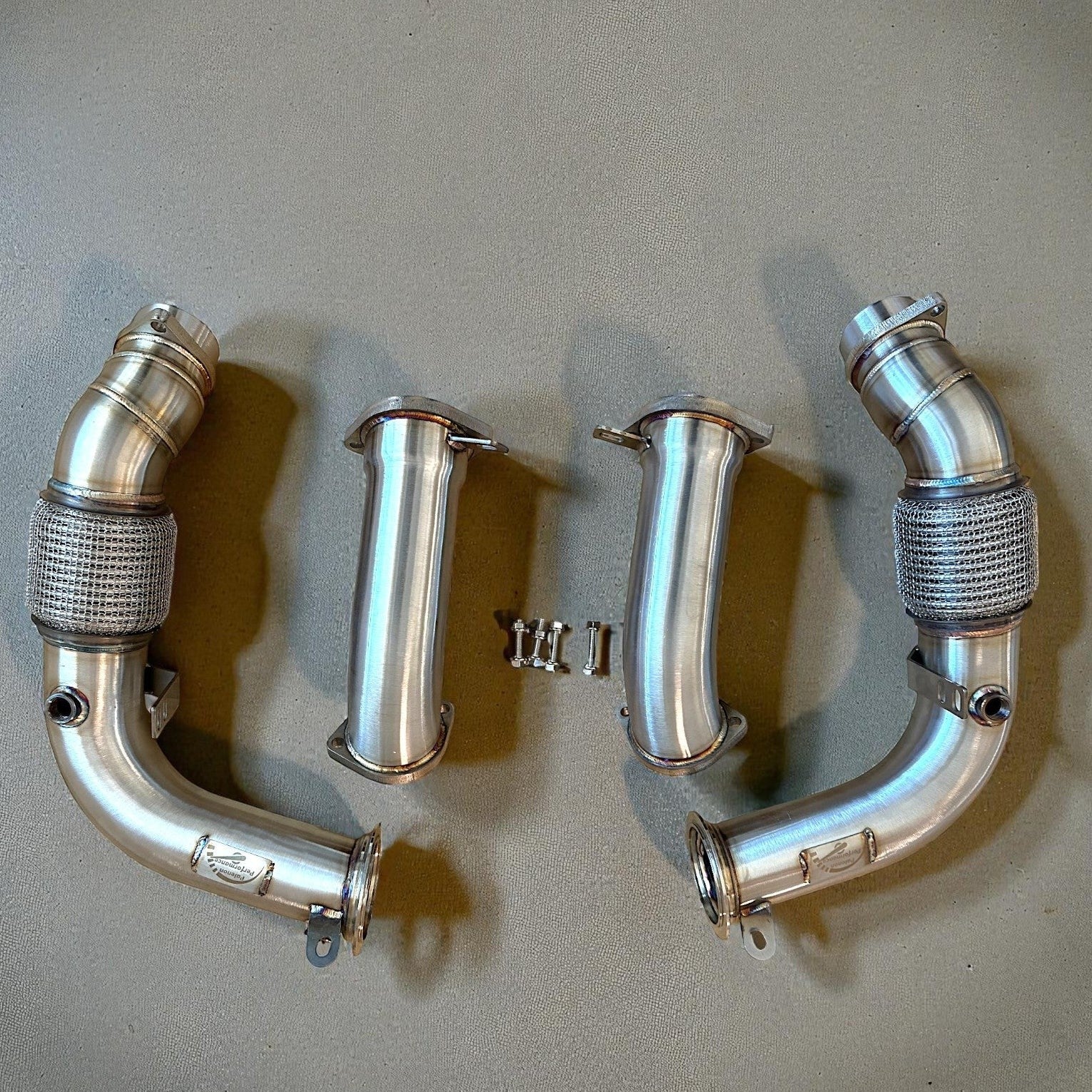 Palenon Performance stainless steel racing downpipes for BMW G90 and G99 M5 with precision flanges and flex sections.