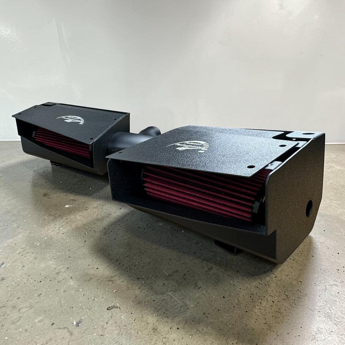 Palenon Performance dual cold air intake system with black heat shields and red reusable filters for M177 engines.