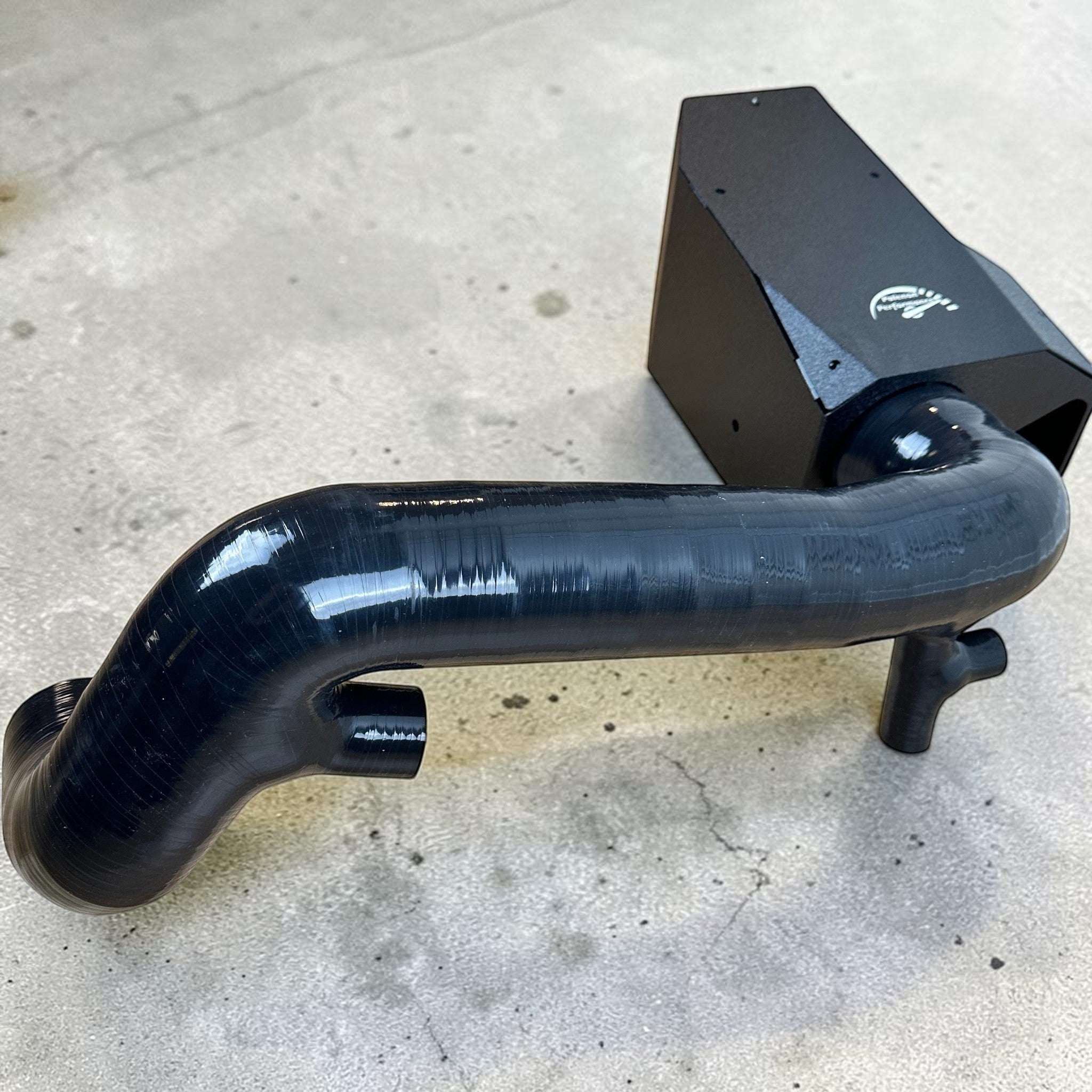 Palenon Performance M264 cold air intake system with black powder-coated heat shield and glossy silicone intake pipe.