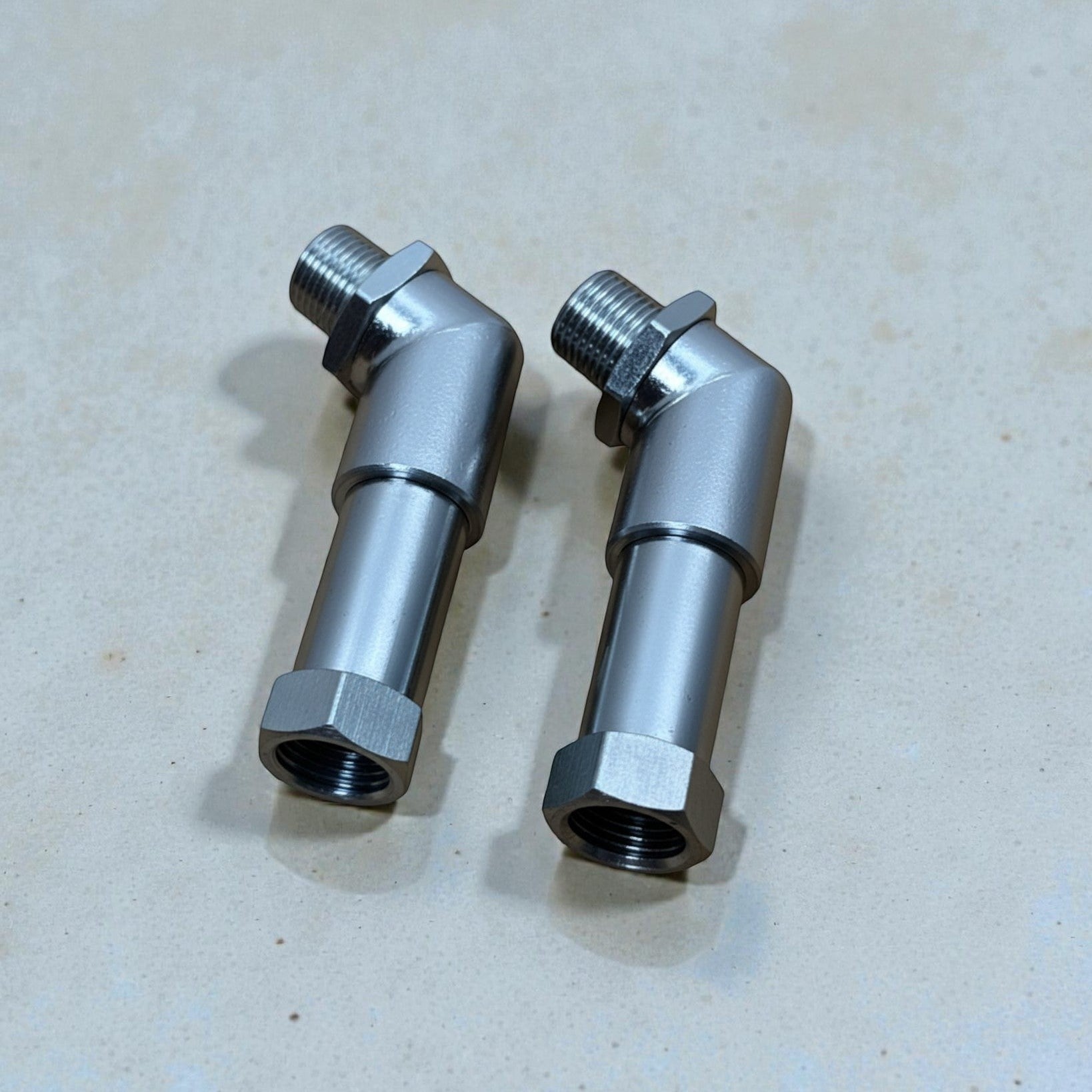 Palenon Performance CEL delete kit featuring two angled stainless steel O2 sensor spacers for catless downpipes.
