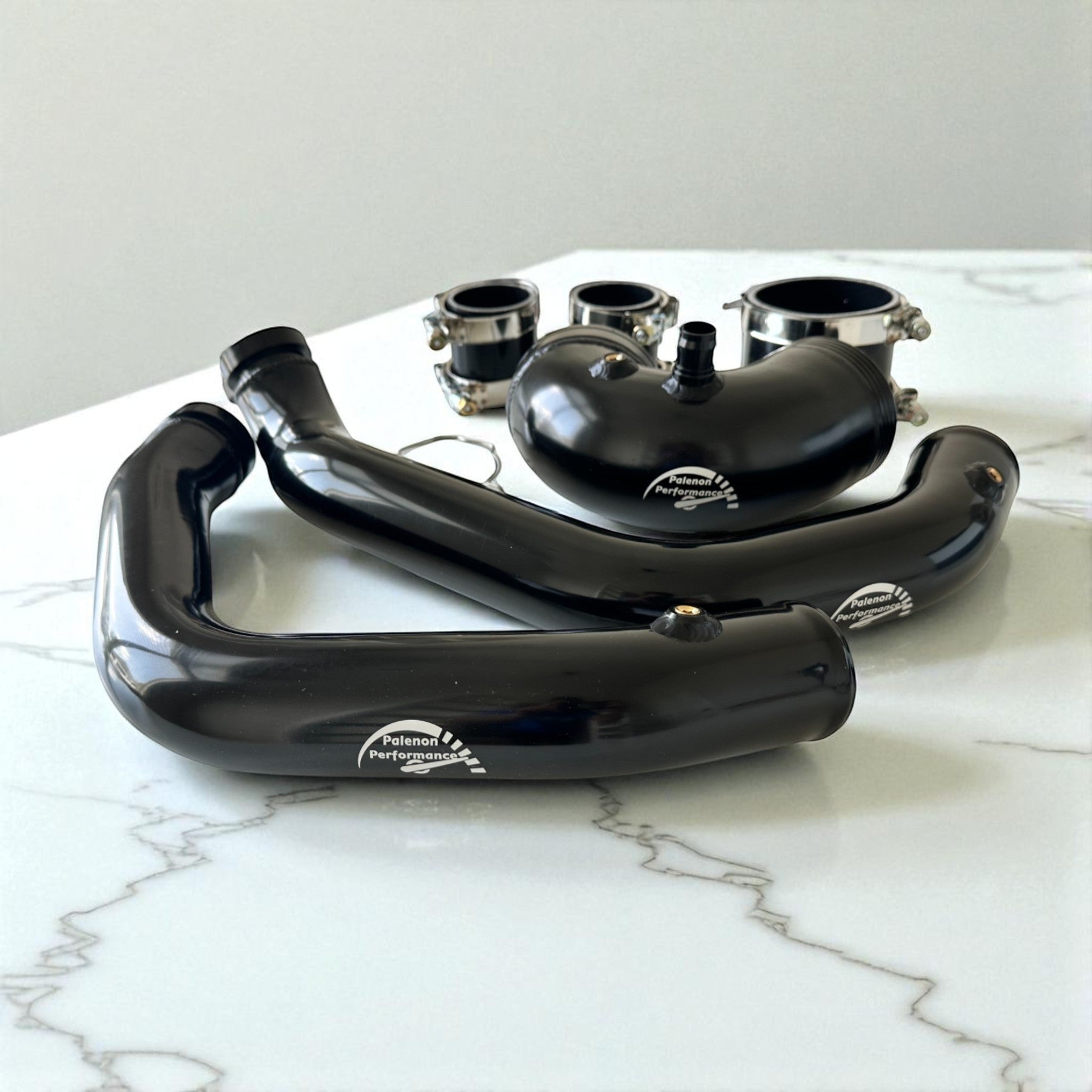Palenon Performance aluminum charge and boost pipes for BMW S55 engines in a wrinkle black finish with mounting hardware.