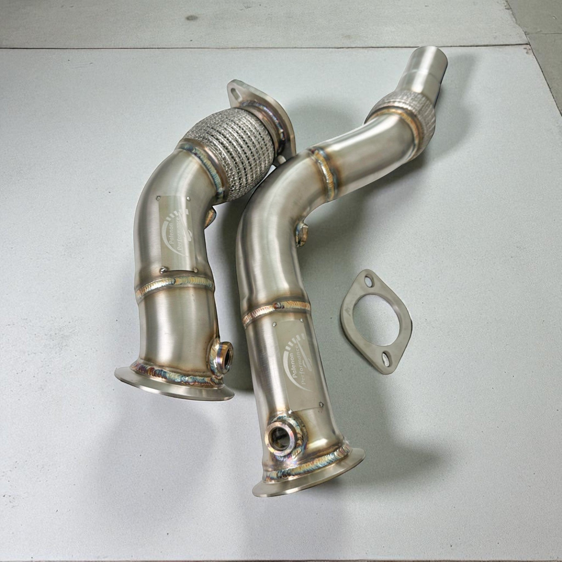 Palenon Performance stainless steel racing downpipes for BMW S55 engines with flex sections and O2 sensor ports.