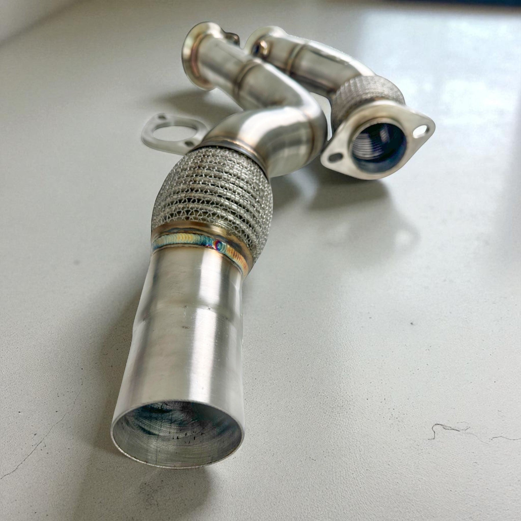 Palenon Performance stainless steel racing downpipe for BMW S55 engines featuring high-flow design and braided flex pipe.