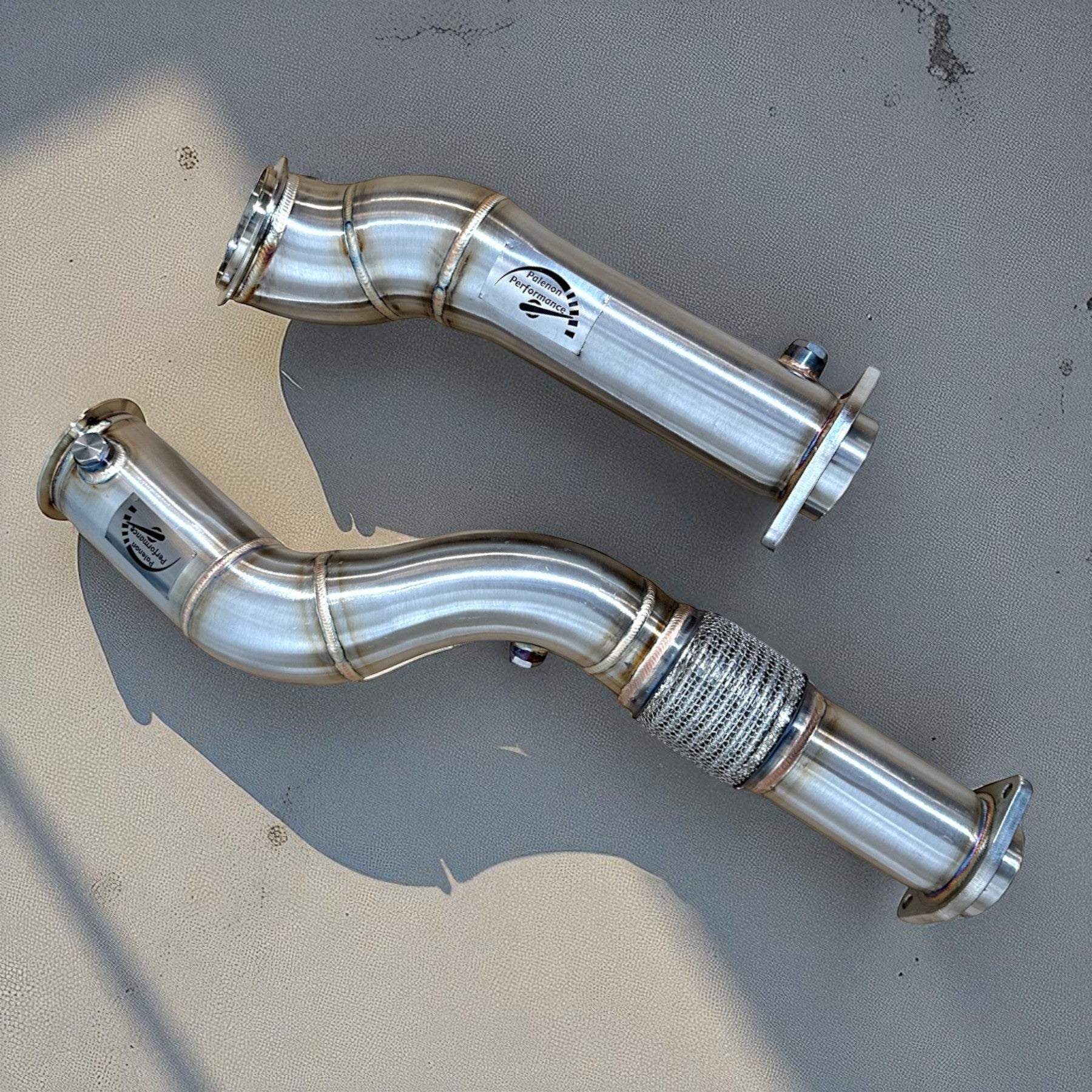 Palenon Performance stainless steel catless downpipes for BMW S58 engine with mandrel-bent design and branding