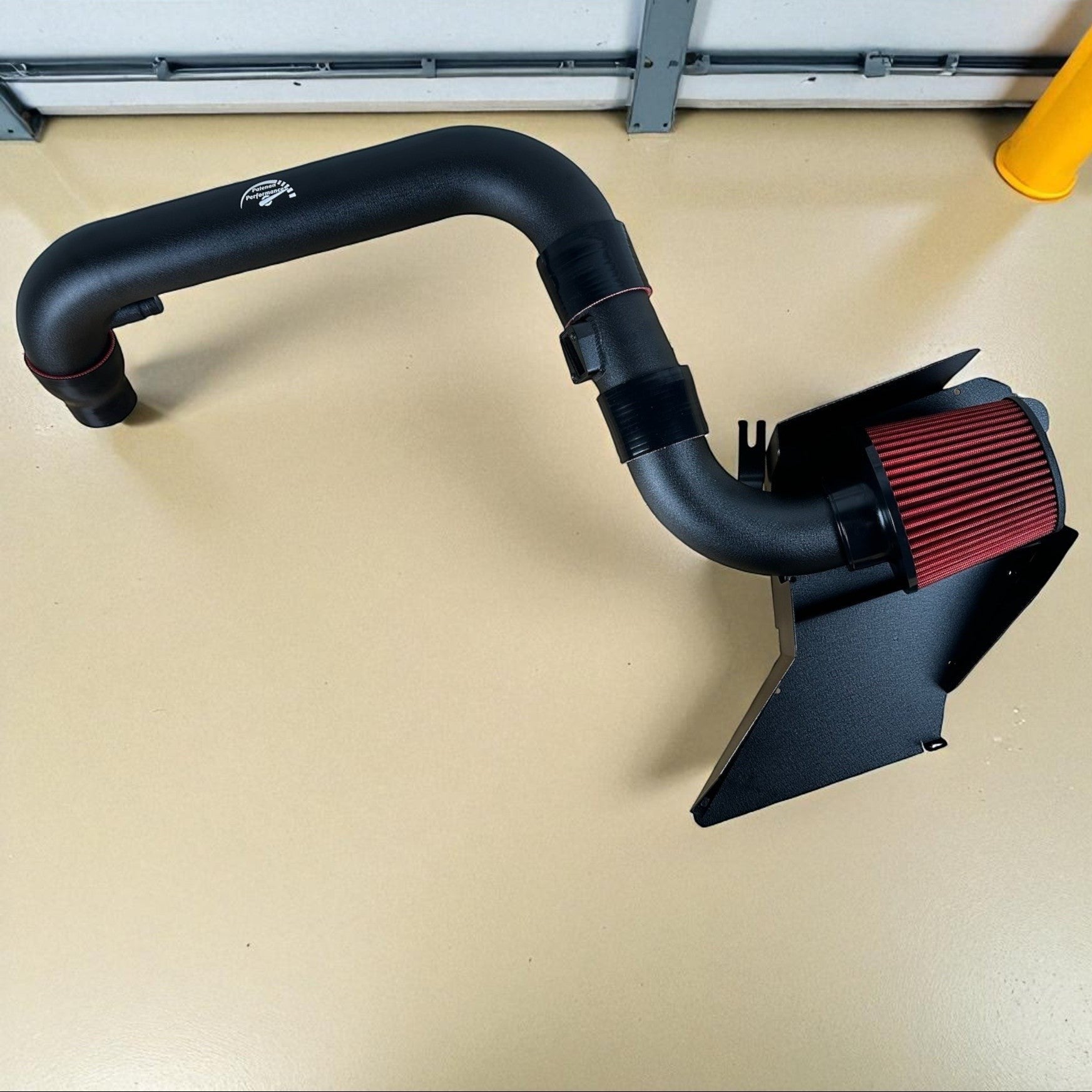 Palenon Performance cold air intake system for VW MK6 with black aluminum piping, red air filter, and heat shield.